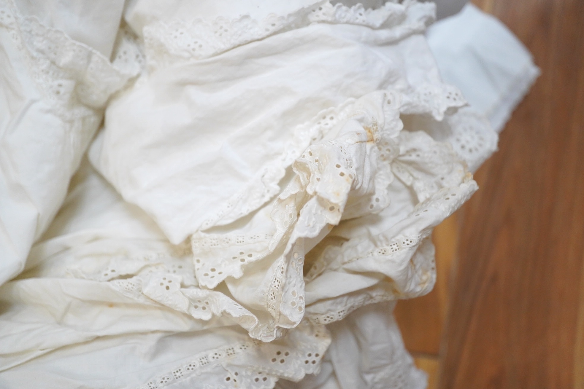 An 18th century cream silk sprig embroidered child’s bodice (unfinished) with two later 19th century cotton long sleeve blouses and four embroidery anglaise edged chemise/bloomers. Condition - the child’s silk bodice nee